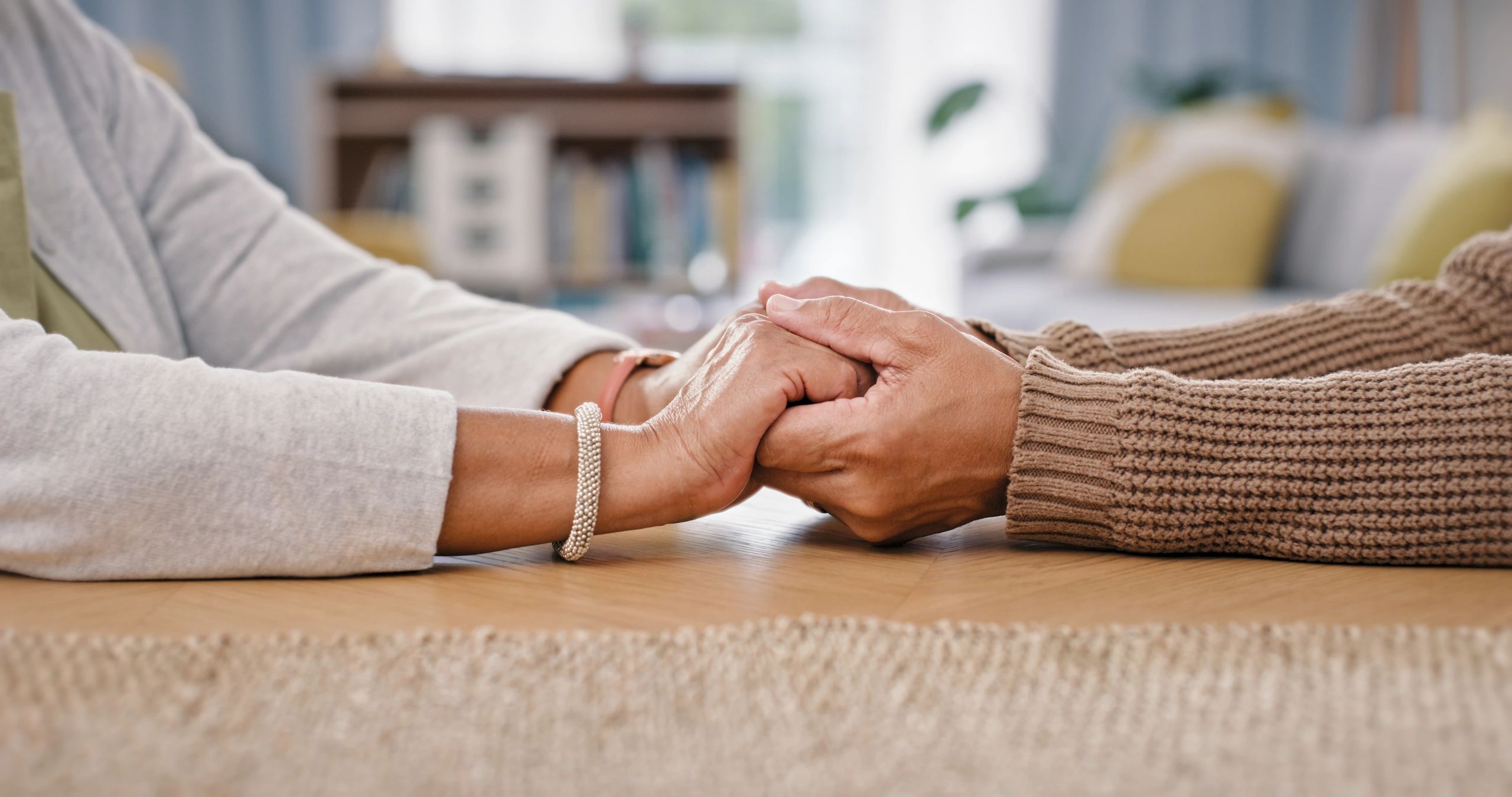 Two people holding hands in warm community fellowship
